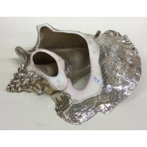 717 - A large silver and stone model of a shell. Approx. 901 grams of gross weight. Est. £200 - £300.