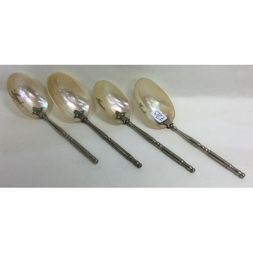 720 - A set of four silver and MOP spoons. Approx. 29 grams. Est. £60 - £80.