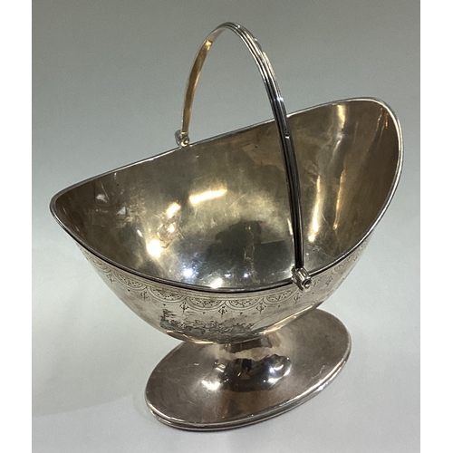 73 - An 18th Century silver swing handled basket with bright-cut decoration. London 1792. By John Robins.... 