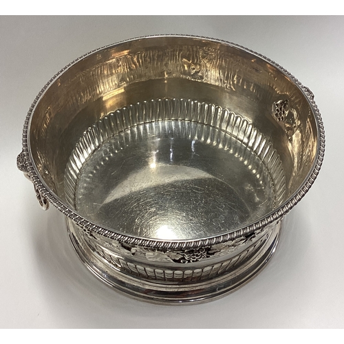 738 - A rare early 20th Century silver ice bucket embossed with grape and vine decoration and cast with ra... 