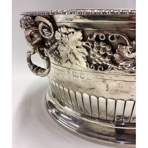 738 - A rare early 20th Century silver ice bucket embossed with grape and vine decoration and cast with ra... 