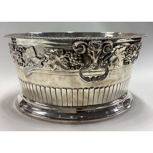 738 - A rare early 20th Century silver ice bucket embossed with grape and vine decoration and cast with ra... 