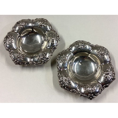 74 - A pair of chased silver dishes embossed with flowers. By Gorham. Approx. 115 grams. Est. £100 - £150... 