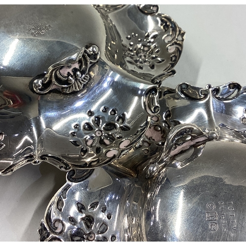 74 - A pair of chased silver dishes embossed with flowers. By Gorham. Approx. 115 grams. Est. £100 - £150... 