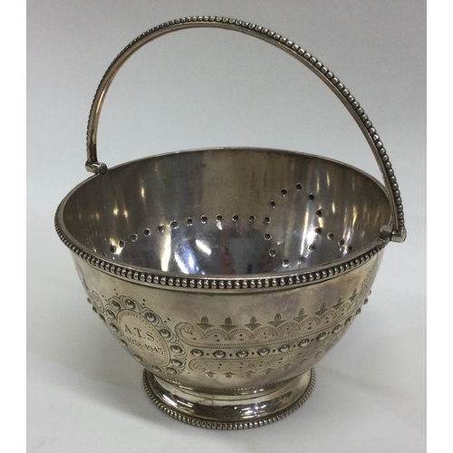 750 - A heavy Victorian silver swing handled basket. London. By JB. Approx. 238 grams. Est. £150 - £250.