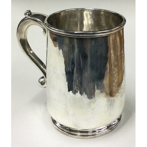 787 - A fine silver pint mug with central armorial. Marked to base. London 1717. By George Lewis. Approx. ... 