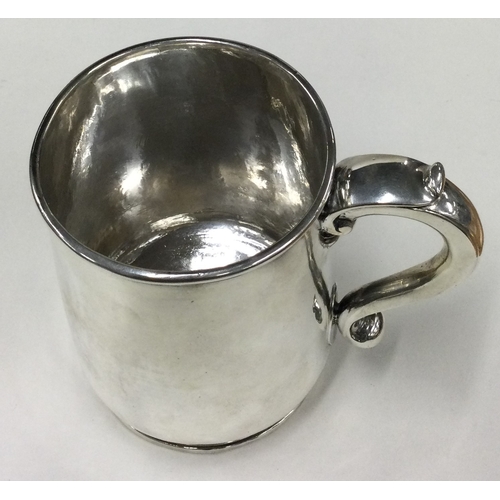 787 - A fine silver pint mug with central armorial. Marked to base. London 1717. By George Lewis. Approx. ... 