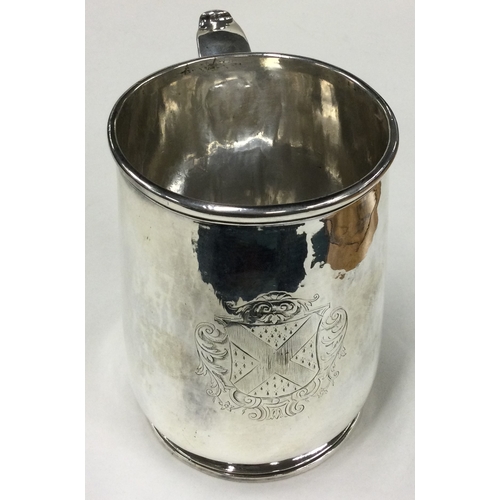 787 - A fine silver pint mug with central armorial. Marked to base. London 1717. By George Lewis. Approx. ... 