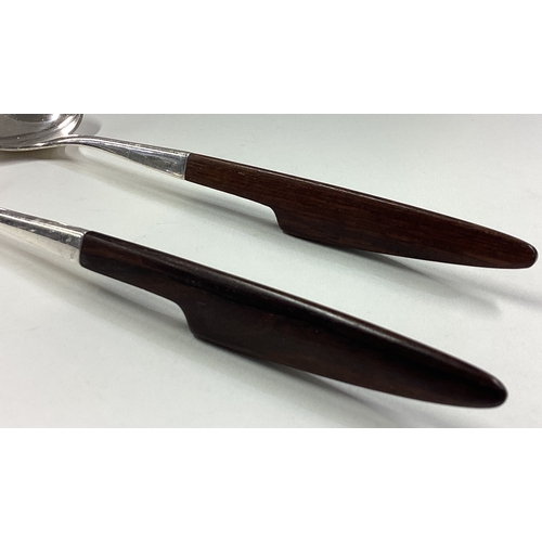 79 - A fine pair of Art Deco silver salad servers with wooden handles in the style of Georg Jensen. Appro... 