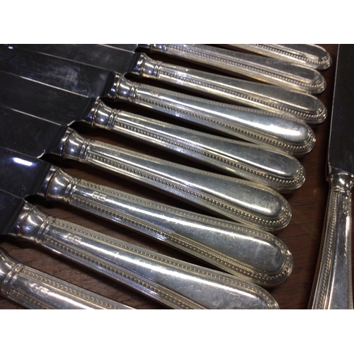 794 - A good set of twelve plus twelve silver handled bead edge knives. London. Est. £100 - £200.