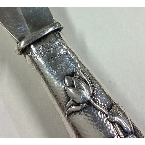 95 - A Japanese silver shoe horn decorated with chased rose water lilies to handle. By Arthur & Bond. App... 