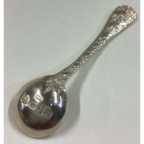 97 - An unusual chased silver salt / mustard spoon. Approx. 28 grams. Est. £20 - £30.