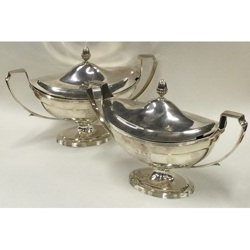 700 - A fine pair of George III silver sauce tureens with crested sides. 1800. By Timothy Renou. Approx. 1... 