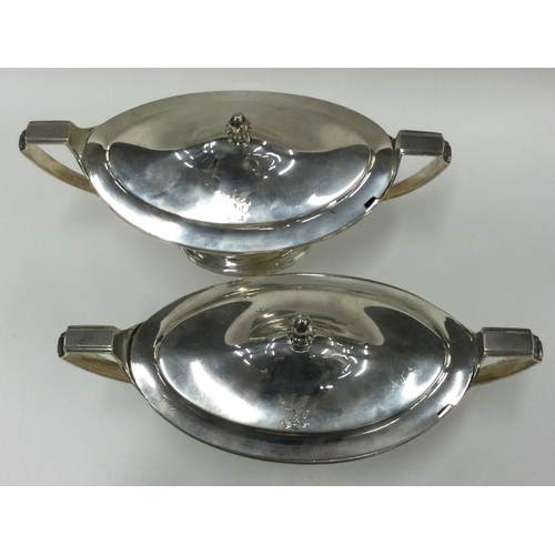 700 - A fine pair of George III silver sauce tureens with crested sides. 1800. By Timothy Renou. Approx. 1... 