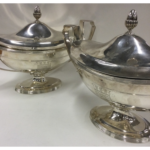 700 - A fine pair of George III silver sauce tureens with crested sides. 1800. By Timothy Renou. Approx. 1... 