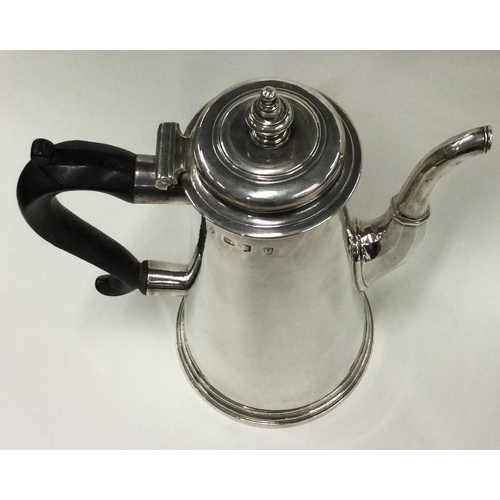 701 - A large tapering Georgian silver straight sided coffee pot. London 1730. By Thomas Farren. Approx. 8... 