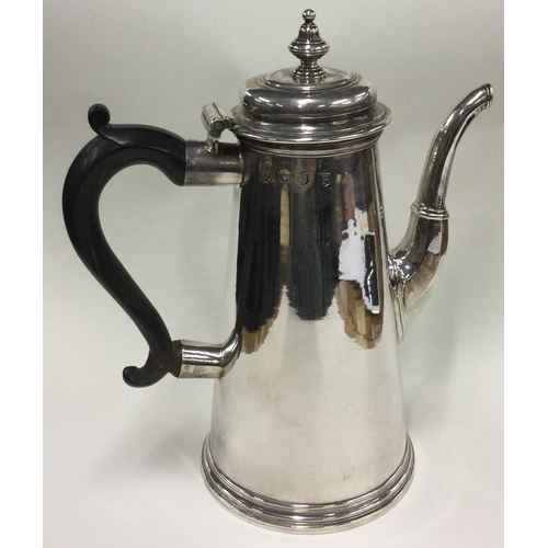 701 - A large tapering Georgian silver straight sided coffee pot. London 1730. By Thomas Farren. Approx. 8... 