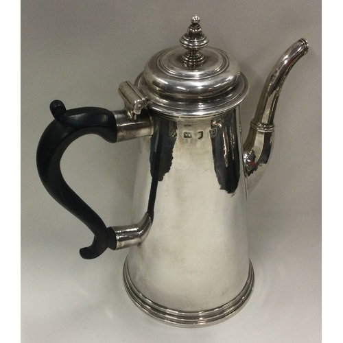 701 - A large tapering Georgian silver straight sided coffee pot. London 1730. By Thomas Farren. Approx. 8... 