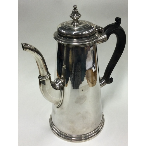 701 - A large tapering Georgian silver straight sided coffee pot. London 1730. By Thomas Farren. Approx. 8... 