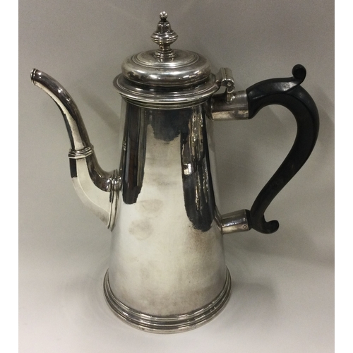 701 - A large tapering Georgian silver straight sided coffee pot. London 1730. By Thomas Farren. Approx. 8... 