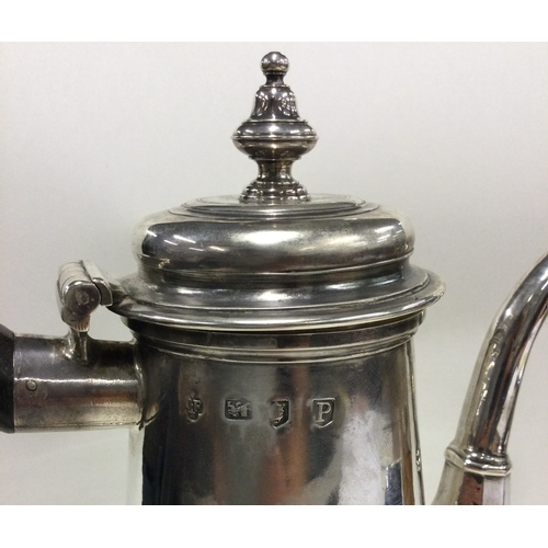 701 - A large tapering Georgian silver straight sided coffee pot. London 1730. By Thomas Farren. Approx. 8... 