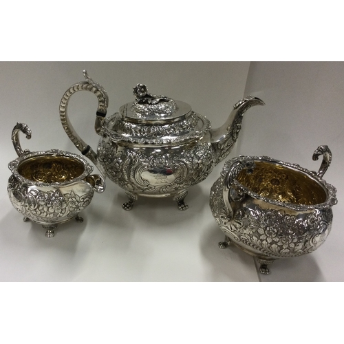 156 - DUBLIN: A George IV Irish silver tea service with crested decoration. 1822. By James Scott. Approx. ... 