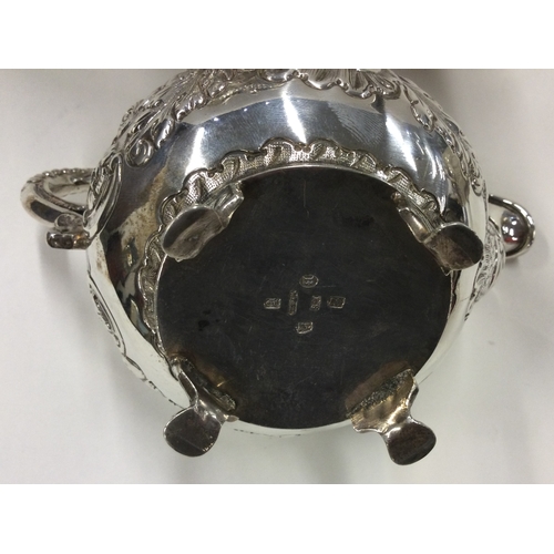 156 - DUBLIN: A George IV Irish silver tea service with crested decoration. 1822. By James Scott. Approx. ... 