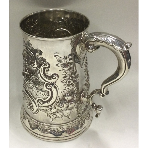 390 - HESTER BATEMAN: A silver one and a half pint tankard with repousse decoration. London 1782. Approx. ... 