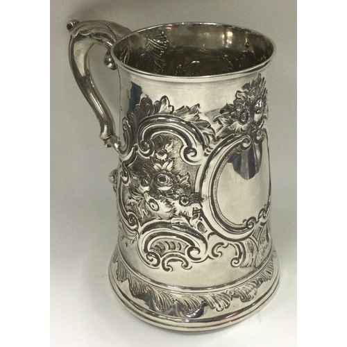 390 - HESTER BATEMAN: A silver one and a half pint tankard with repousse decoration. London 1782. Approx. ... 