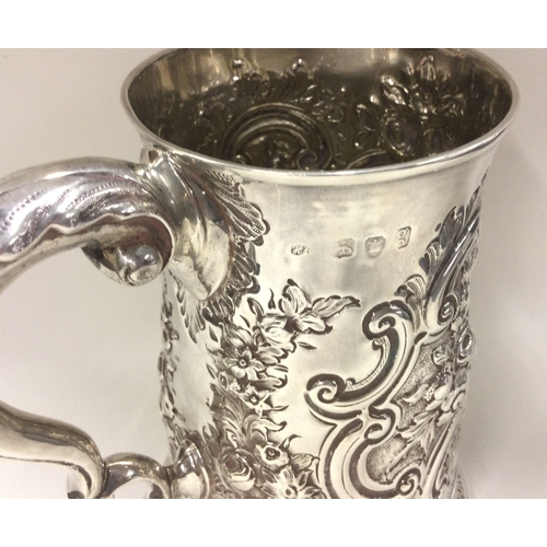 390 - HESTER BATEMAN: A silver one and a half pint tankard with repousse decoration. London 1782. Approx. ... 