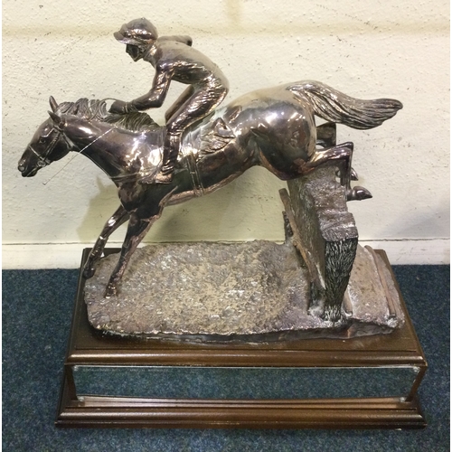 768 - A large silver trophy cup in the form of a racehorse with textured body. London. Est. £150 - £200.