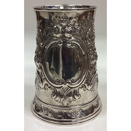 390 - HESTER BATEMAN: A silver one and a half pint tankard with repousse decoration. London 1782. Approx. ... 