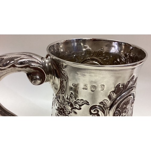 390 - HESTER BATEMAN: A silver one and a half pint tankard with repousse decoration. London 1782. Approx. ... 