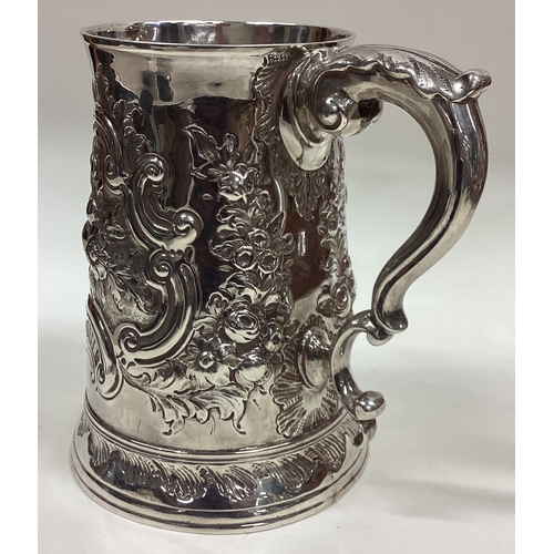 390 - HESTER BATEMAN: A silver one and a half pint tankard with repousse decoration. London 1782. Approx. ... 