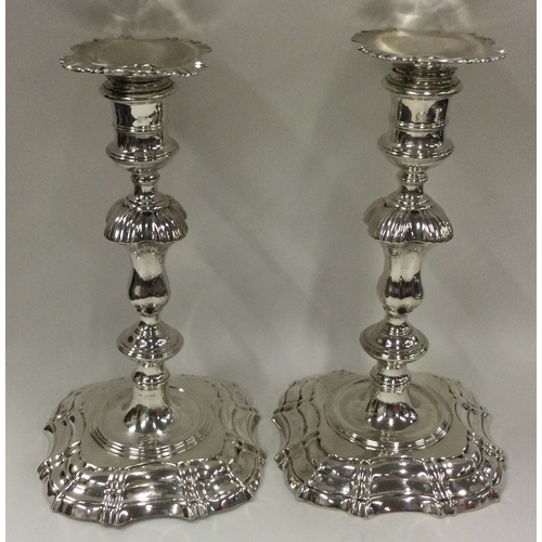 253 - A matched pair of cast silver candlesticks. 1743, by James Gould and 1817, by Samuel Hennell. With m... 