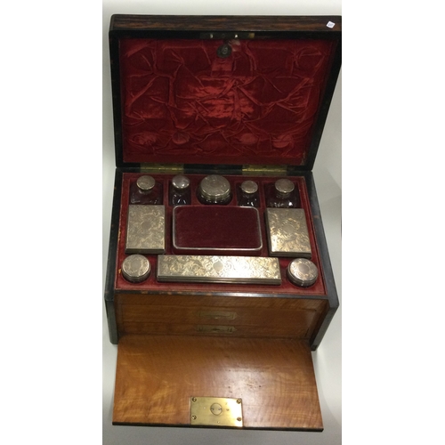 796 - A good quality Victorian silver mounted travelling set of scent bottles contained within wooden case... 