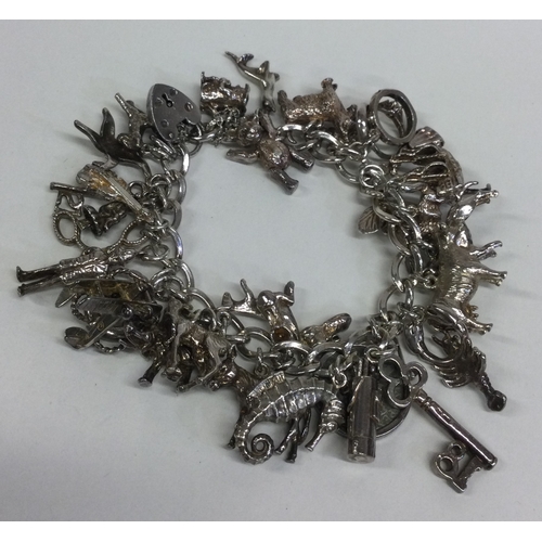 808 - A silver charm bracelet. Approx. 105 grams. Est. £30 - £40.