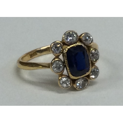 821 - A sapphire and diamond oval cluster ring with rub over mount in 18 carat gold setting. Approx. 4 gra... 