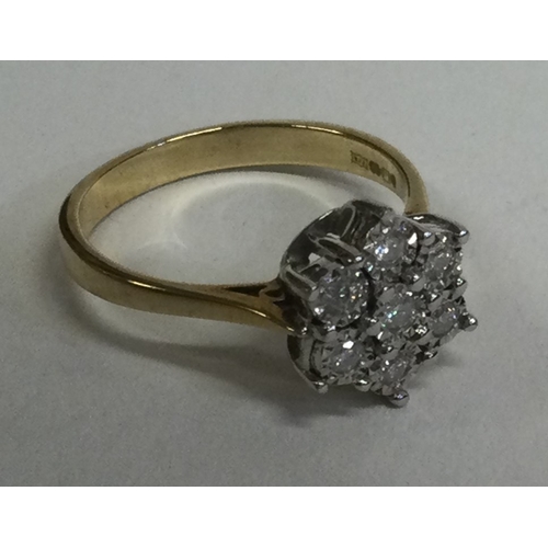 832 - A good diamond seven stone cluster ring in 9 carat setting. Approx. 3 grams. Est. £50 - £80.