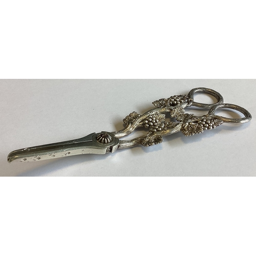 797 - A good pair of Victorian cast silver grape scissors decorated with vines. London 1863. By William Su... 