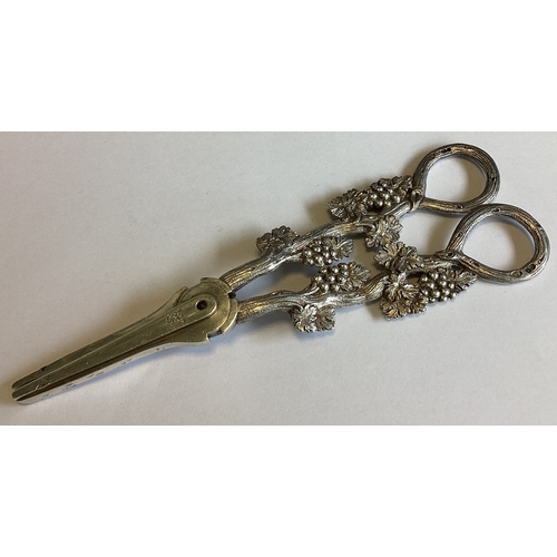 797 - A good pair of Victorian cast silver grape scissors decorated with vines. London 1863. By William Su... 