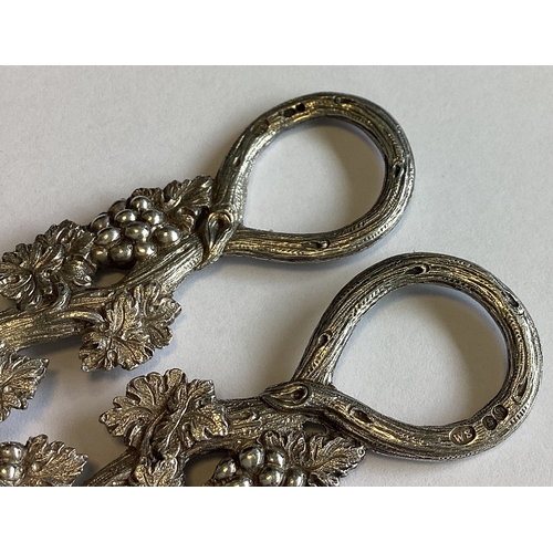 797 - A good pair of Victorian cast silver grape scissors decorated with vines. London 1863. By William Su... 