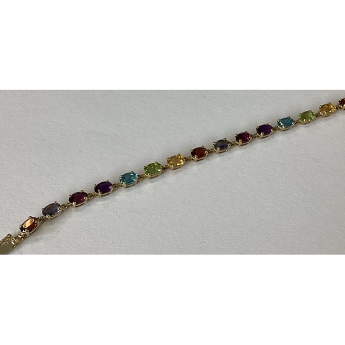 857 - A good 9 carat multi gem set bracelet with concealed clasp. Approx. 5 grams. Est. £50 - £80.