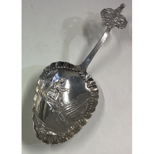 134 - A Dutch silver caddy spoon with chased decoration. Approx. 17 grams. Est. £30 - £40.