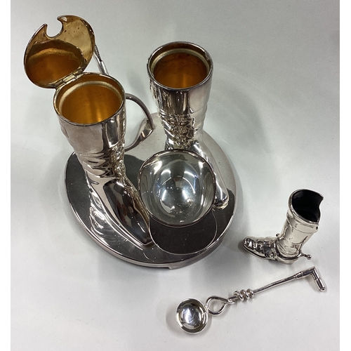 210 - A good quality silver plated cruet set in the form of a jockey's cap and boots. Est. £30 - £50.