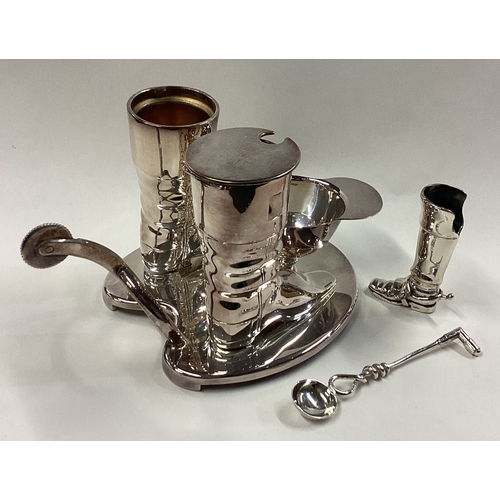 210 - A good quality silver plated cruet set in the form of a jockey's cap and boots. Est. £30 - £50.