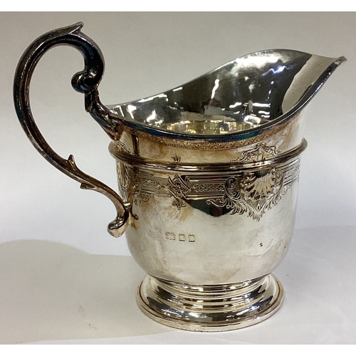 271 - A fine quality silver cream jug attractively decorated with flowers and scrolls in the Georgian styl... 