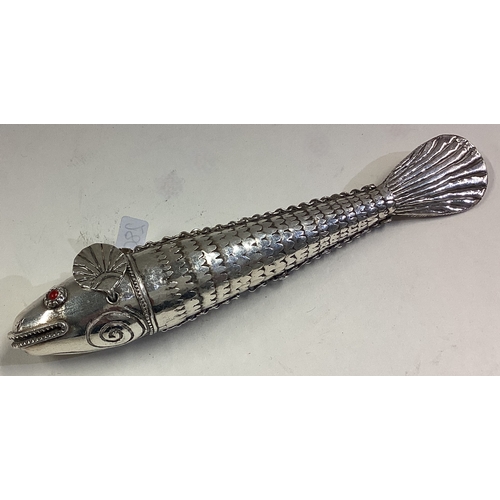 280 - An articulated Antique silver figure of a fish with red stone eyes. Approx. 82 grams. Est. £150 - £2... 