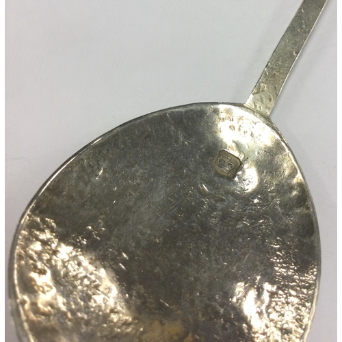 311 - A modern Arts & Crafts silver seal top spoon. By M Bros. Approx. 24 grams. Est. £30 - £40.