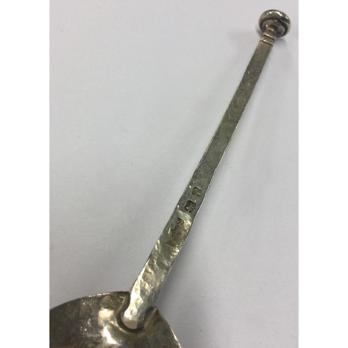 311 - A modern Arts & Crafts silver seal top spoon. By M Bros. Approx. 24 grams. Est. £30 - £40.